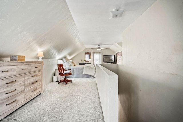 carpeted bedroom featuring vaulted ceiling and a textured ceiling