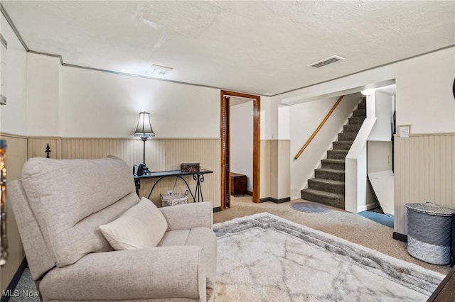 living area featuring light carpet and a textured ceiling