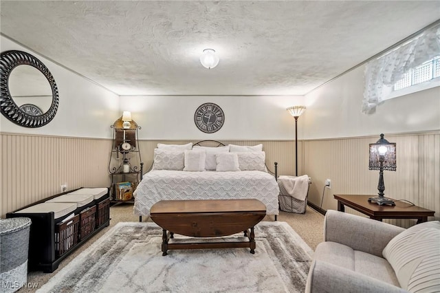 bedroom featuring light carpet and a textured ceiling