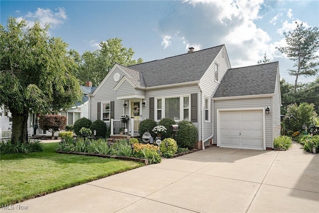 view of front of property featuring a garage and a front lawn