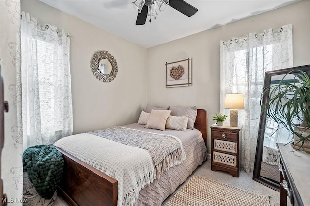 bedroom with multiple windows and ceiling fan