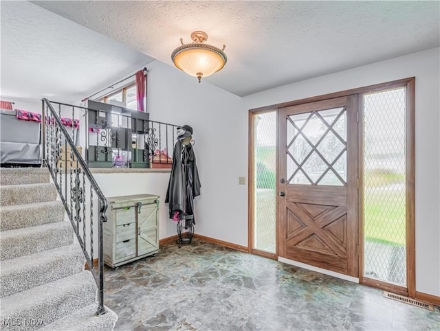 entryway featuring plenty of natural light and a textured ceiling