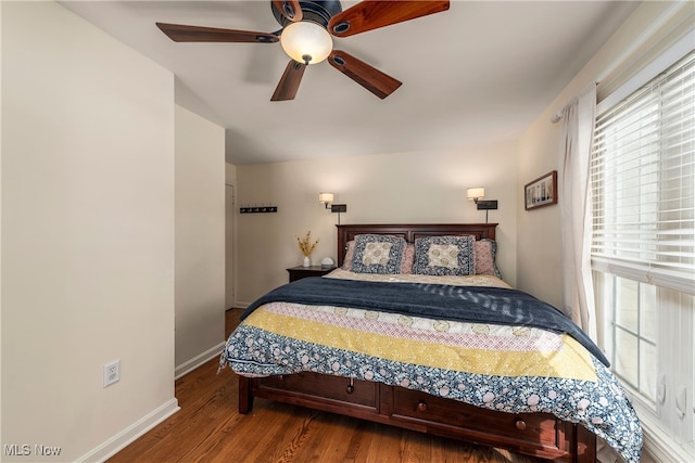 bedroom featuring ceiling fan, baseboards, and wood finished floors