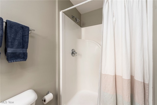 bathroom with toilet and curtained shower