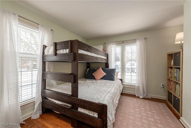 bedroom with wood finished floors and baseboards