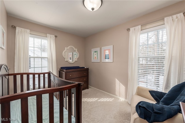 carpeted bedroom featuring baseboards