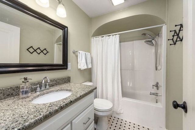 bathroom with toilet, shower / tub combo, and vanity