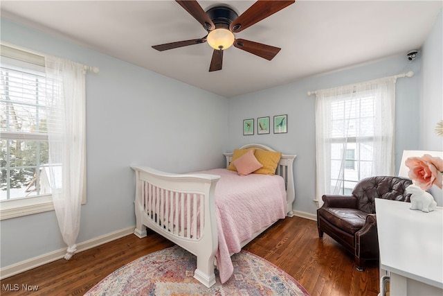 bedroom with a ceiling fan, baseboards, and wood finished floors