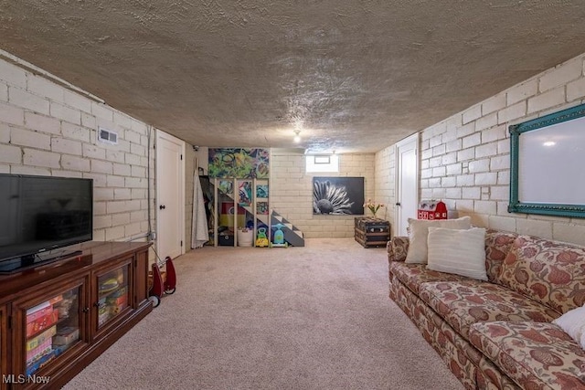 living area with a textured ceiling, visible vents, carpet, and concrete block wall