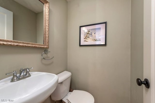 half bath featuring a sink and toilet