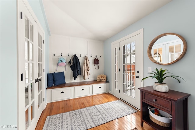 mudroom featuring light wood-style floors, lofted ceiling, and french doors