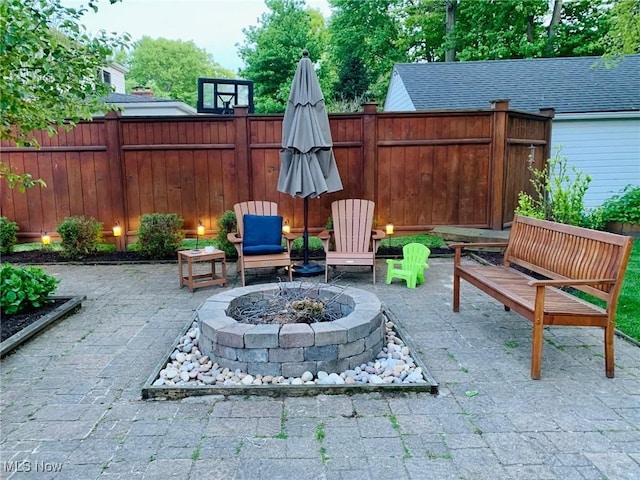 view of patio / terrace with an outdoor fire pit and fence private yard