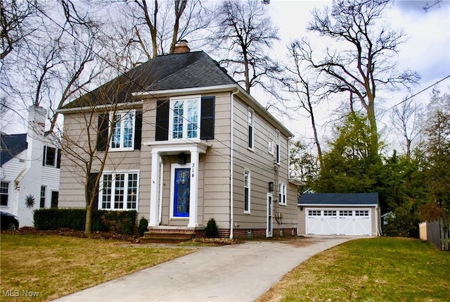 view of front of property featuring a garage, a shingled roof, a chimney, an outbuilding, and a front lawn