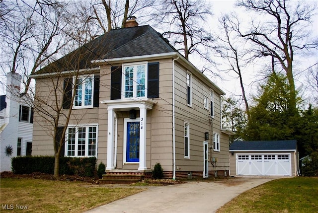 view of front facade with a garage, concrete driveway, a chimney, roof with shingles, and an outdoor structure