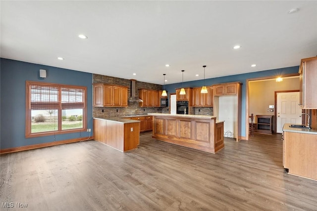 6470 Aberdeen Ln, Medina, OH 44256 - kitchen with wall chimney range hood, black appliances, wood finished floors, decorative backsplash, and baseboards
