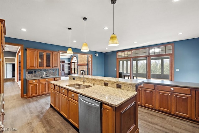 6470 Aberdeen Ln, Medina, OH 44256 - kitchen with a sink, dishwasher, light wood-type flooring, brown cabinetry, and decorative backsplash