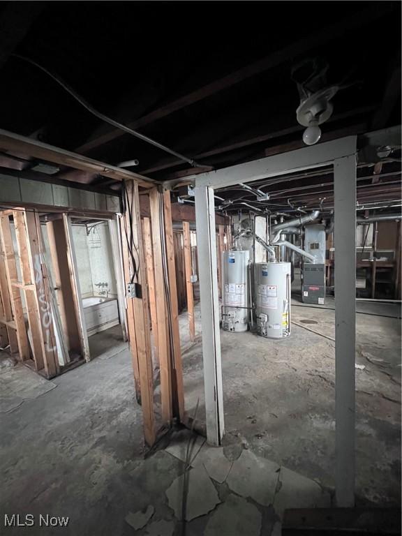 unfinished basement featuring water heater