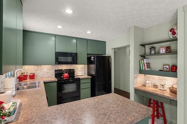 kitchen with a breakfast bar area, a peninsula, light countertops, black appliances, and a sink