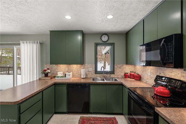 kitchen with backsplash, green cabinets, a sink, a peninsula, and black appliances