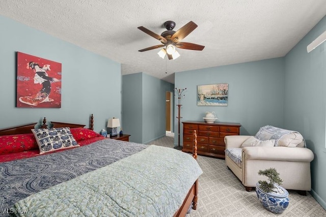 bedroom with light carpet, ceiling fan, a textured ceiling, and baseboards