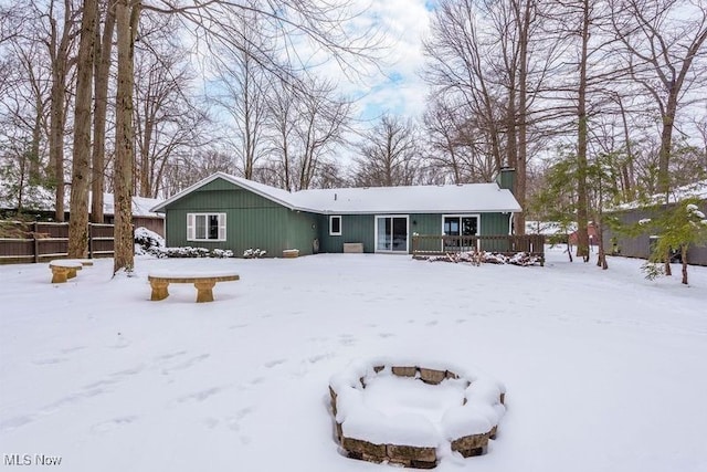 view of snow covered back of property