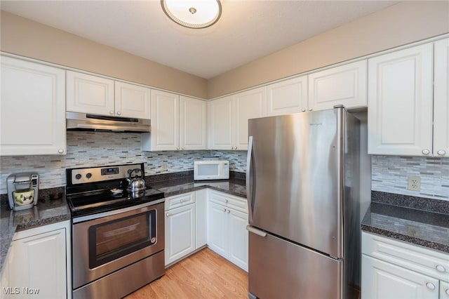 kitchen with white cabinetry, stainless steel appliances, and under cabinet range hood