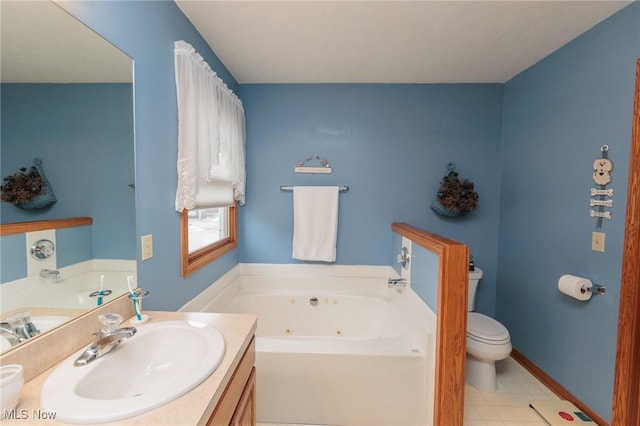 bathroom featuring a tub with jets, baseboards, toilet, and vanity