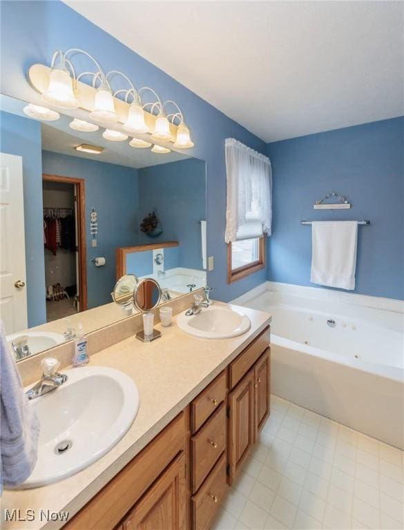 full bath featuring double vanity, a bath, and a sink