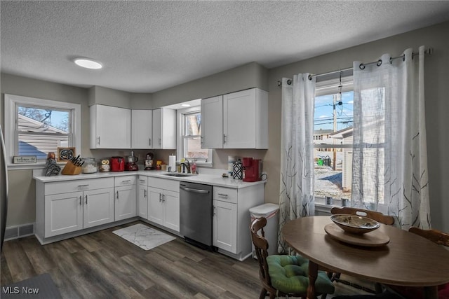 kitchen with dishwasher, white cabinets, sink, and dark hardwood / wood-style floors