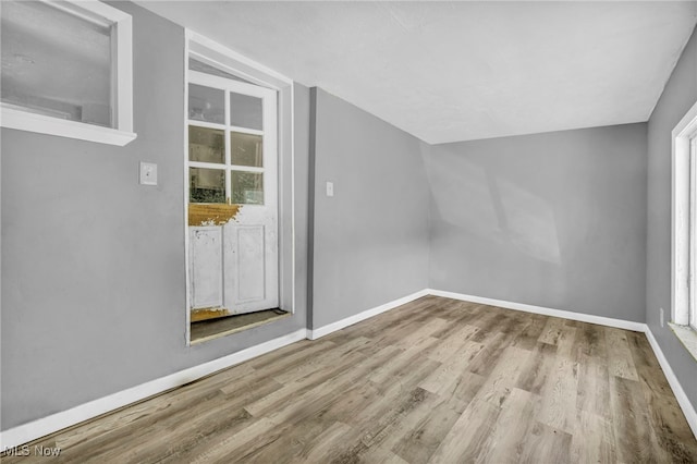 additional living space with light hardwood / wood-style floors