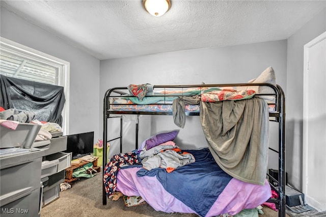 bedroom with carpet flooring and a textured ceiling