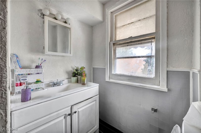 bathroom featuring tile walls and vanity