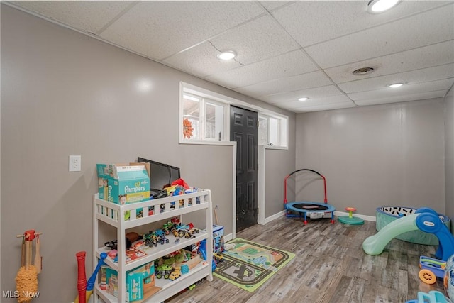 rec room featuring a paneled ceiling and hardwood / wood-style flooring