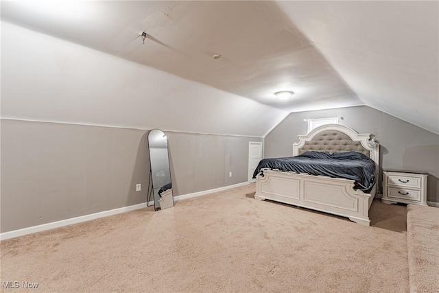 bedroom featuring carpet and vaulted ceiling