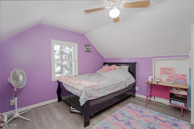 bedroom featuring light hardwood / wood-style flooring, vaulted ceiling, and ceiling fan