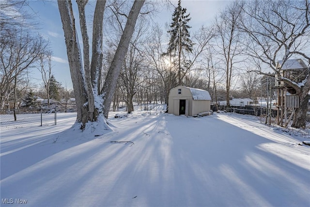 snowy yard with a shed