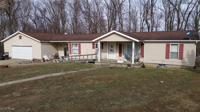 view of front of house featuring a garage, covered porch, driveway, and a front lawn