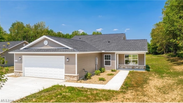 ranch-style house featuring a shingled roof, a front yard, a garage, stone siding, and driveway