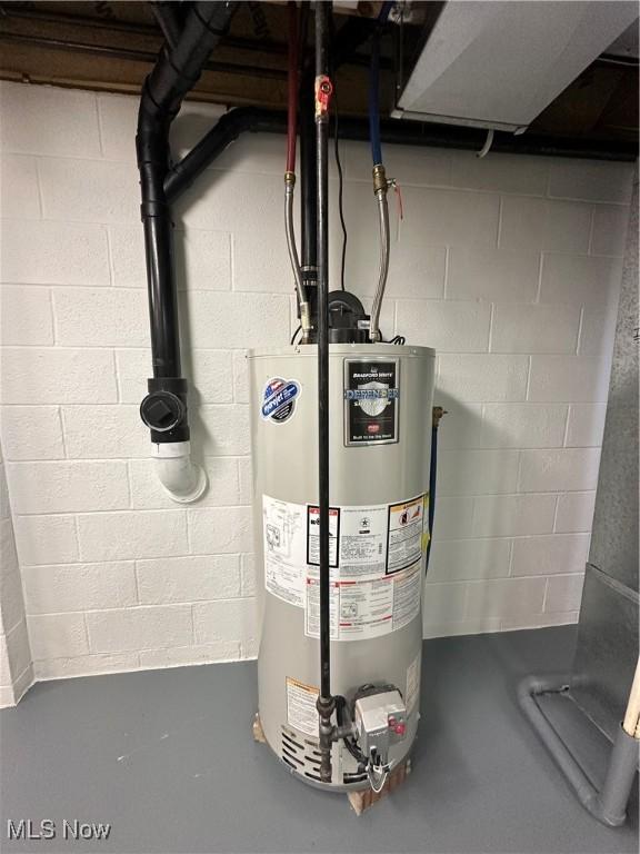 utility room with gas water heater