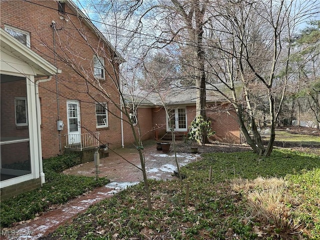 exterior space featuring a patio area and brick siding