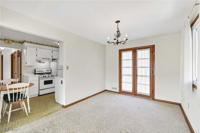 dining room with baseboards, french doors, light carpet, and an inviting chandelier