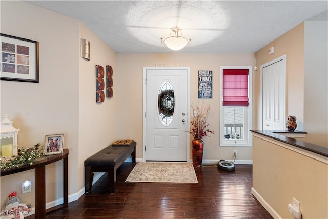 entryway featuring dark wood-style floors, baseboards, and a textured ceiling