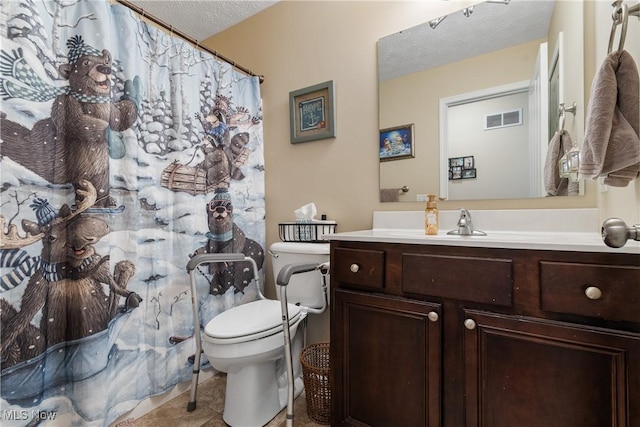 full bath featuring a textured ceiling, toilet, vanity, visible vents, and tile patterned floors