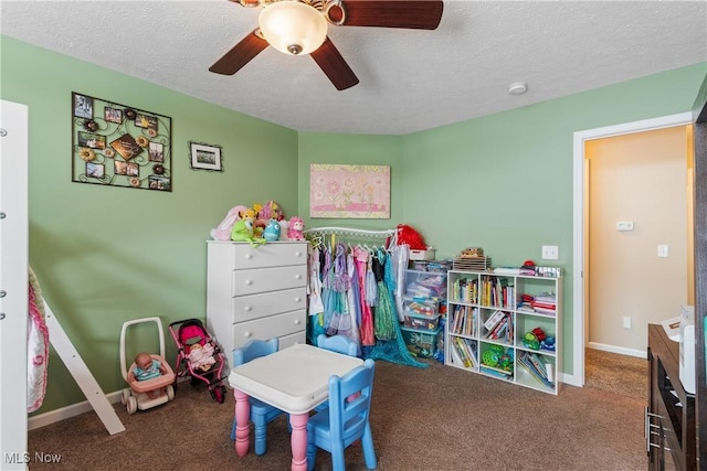 game room with a textured ceiling, ceiling fan, carpet, and baseboards