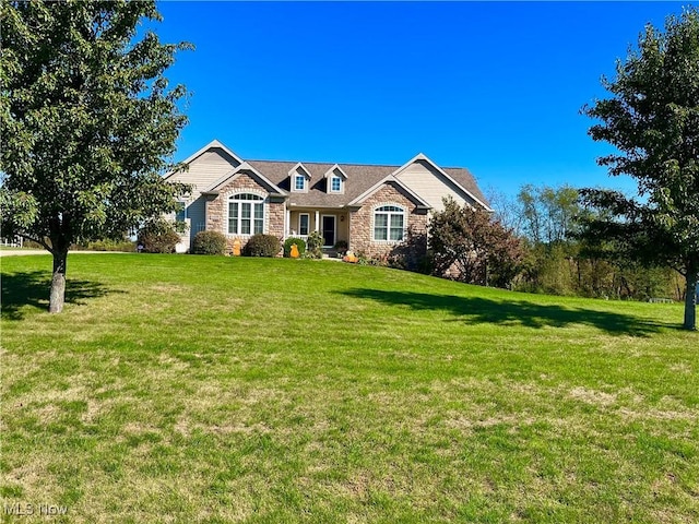 view of front of property featuring stone siding and a front yard