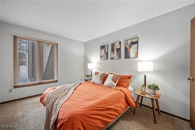 carpeted bedroom with a textured ceiling and baseboards