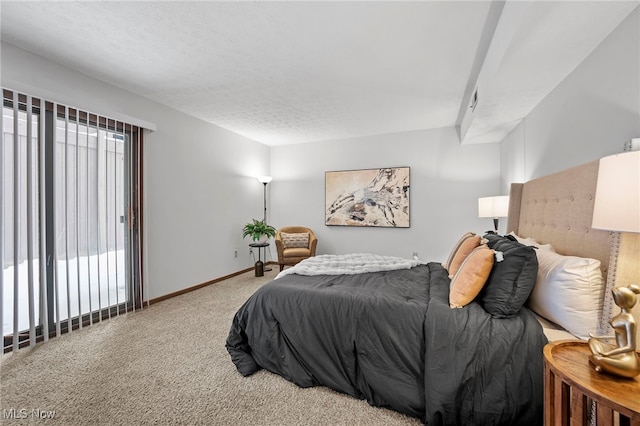 bedroom with carpet, baseboards, and a textured ceiling