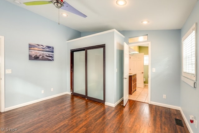 unfurnished bedroom featuring dark wood-style floors, recessed lighting, a closet, visible vents, and baseboards