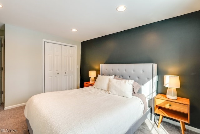 bedroom with light carpet, baseboards, a closet, and recessed lighting