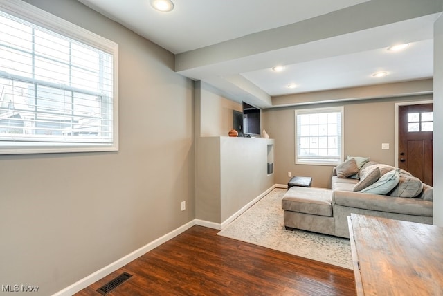 unfurnished living room with recessed lighting, dark wood finished floors, visible vents, and baseboards